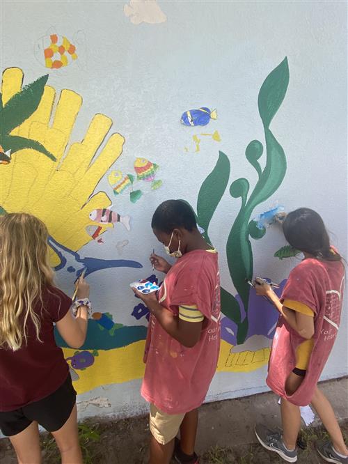 Students at Blanton Mural camp paint fish